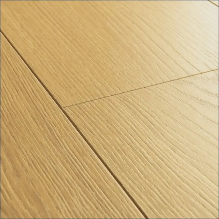 Quickstep capture light oak laminate floor planks with natural varnished oak grain pattern for stylish interiors