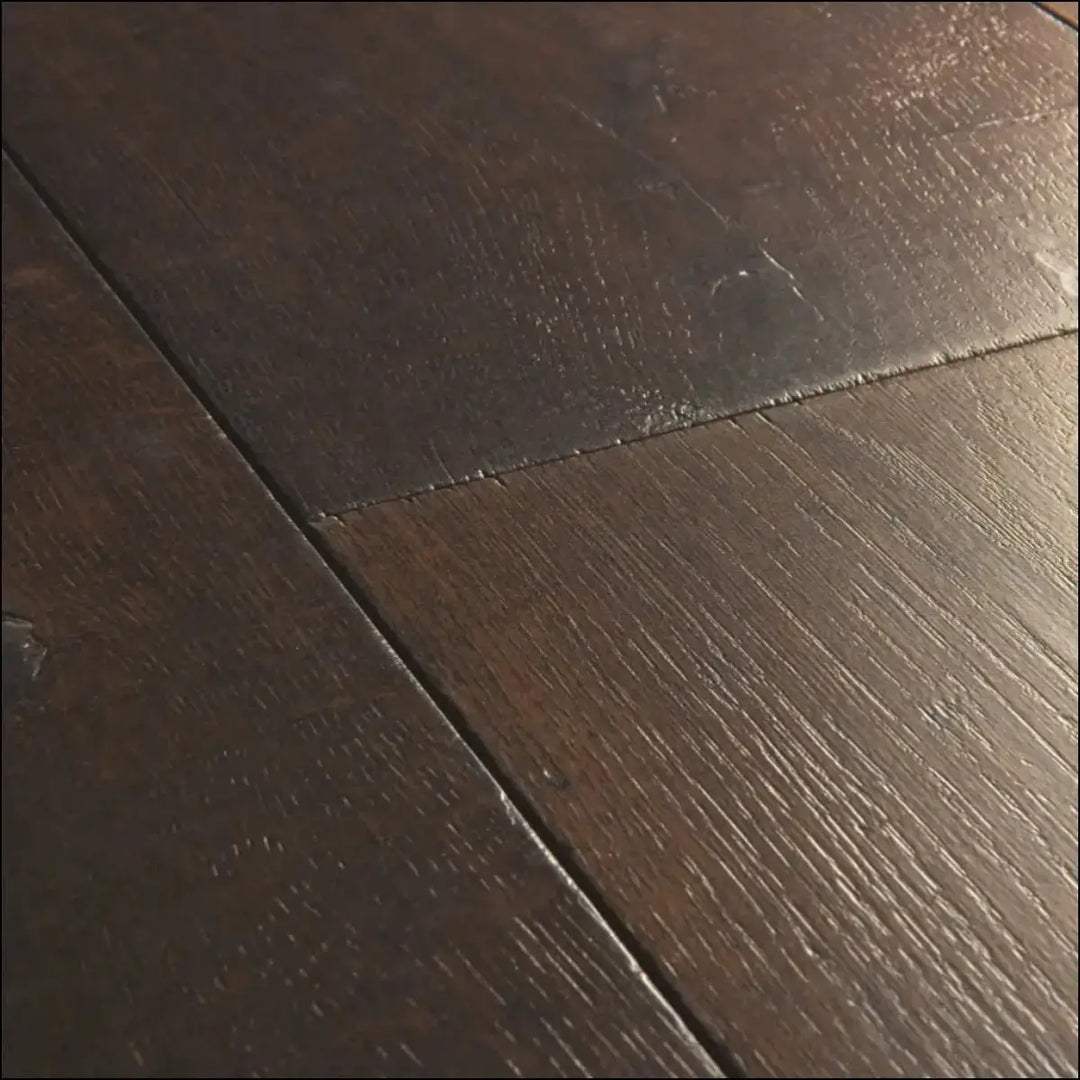 Dark brown hardwood floor planks with natural grain pattern in quick-step capture waxed oak brown laminate flooring