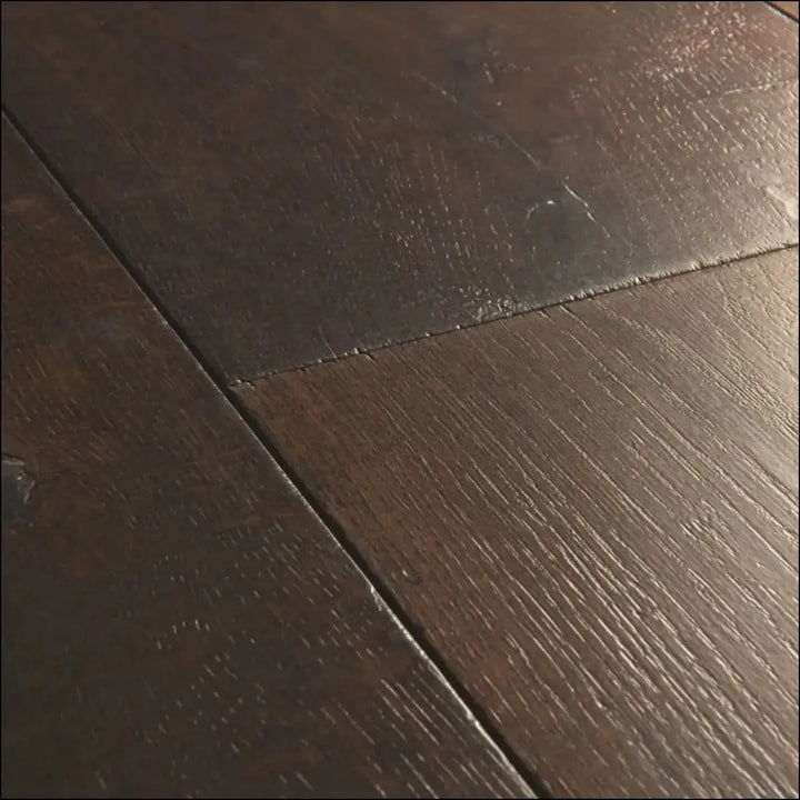 Dark brown hardwood floor planks with natural grain pattern in quick-step capture waxed oak brown laminate flooring