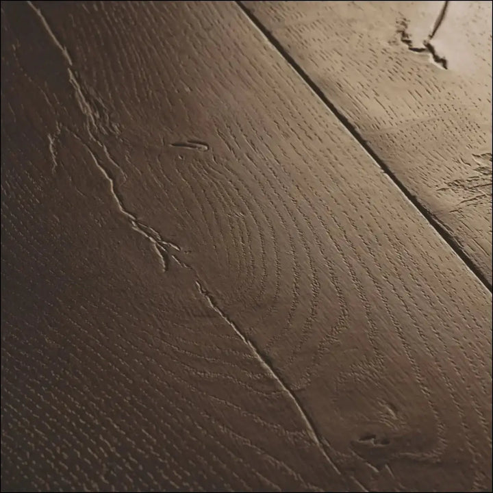 Dark brown quick-step capture waxed oak brown laminate floorboards with natural grain patterns and cracks visible