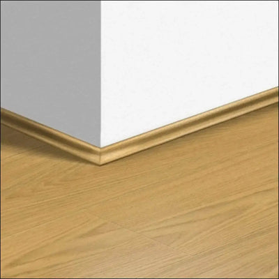Light oak quickstep capture scotia wooden baseboard with smooth finish covering expansion gaps on capture laminate flooring corner