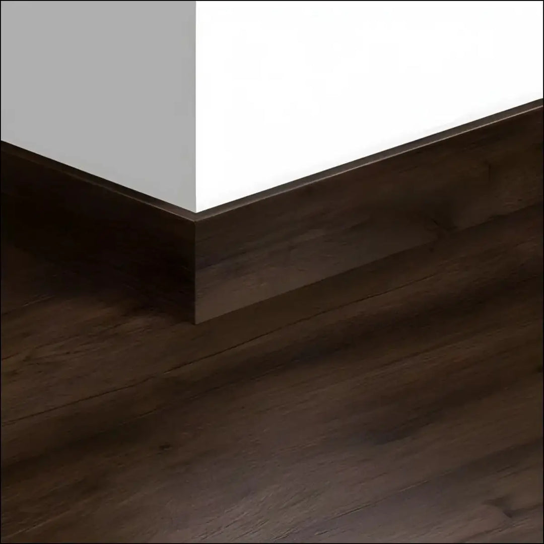 Dark brown wood-grain quickstep capture skirting board 77mm with a sleek modern profile for laminate floors