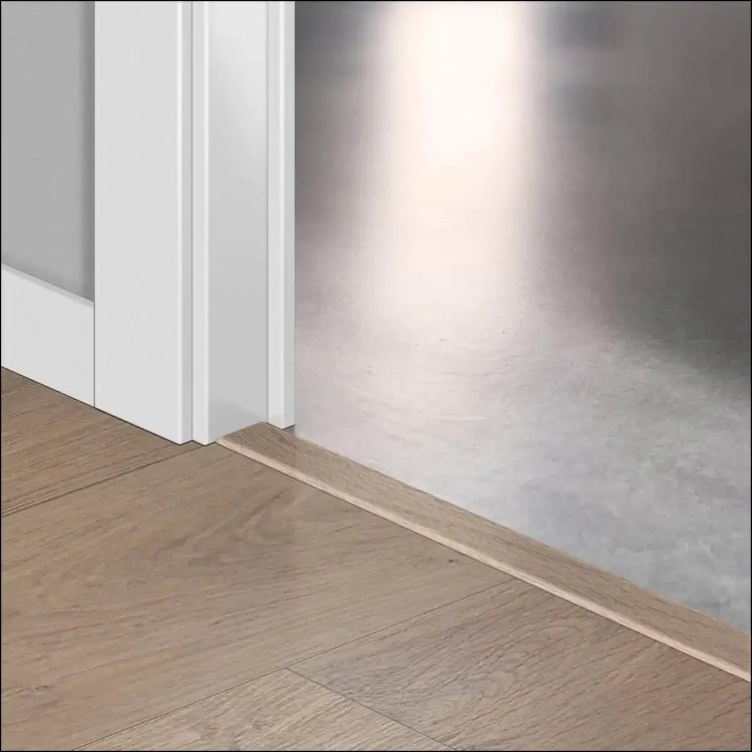 Light-colored wooden baseboard trim with quickstep classic incizo profile for a clean multi-use profile finish
