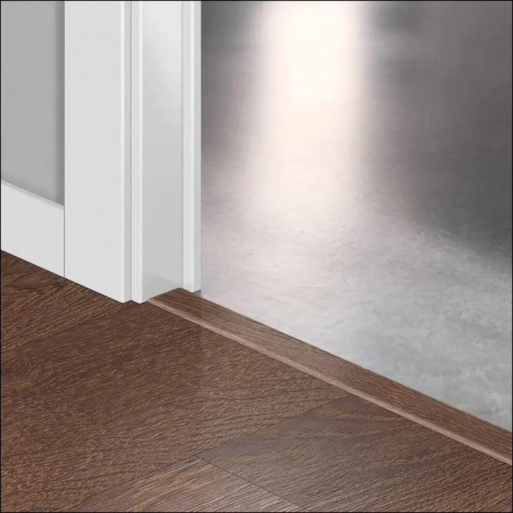 Brown wooden floor trim with smooth polished finish in quickstep classic incizo profile multi-use profile design