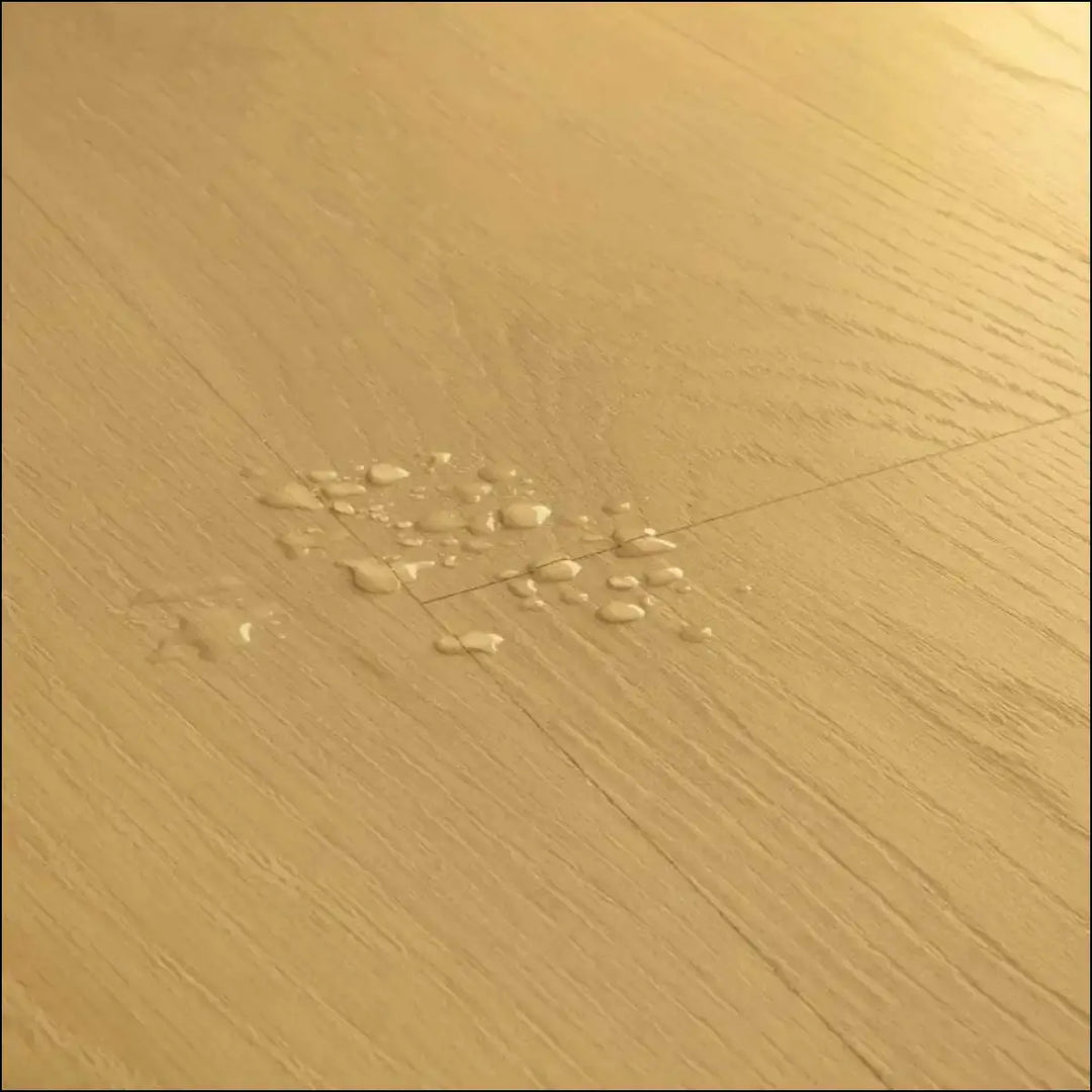 Light brown biscuit brown oak quick-step classic laminate flooring clm5794 with visible grain and water droplets on planks
