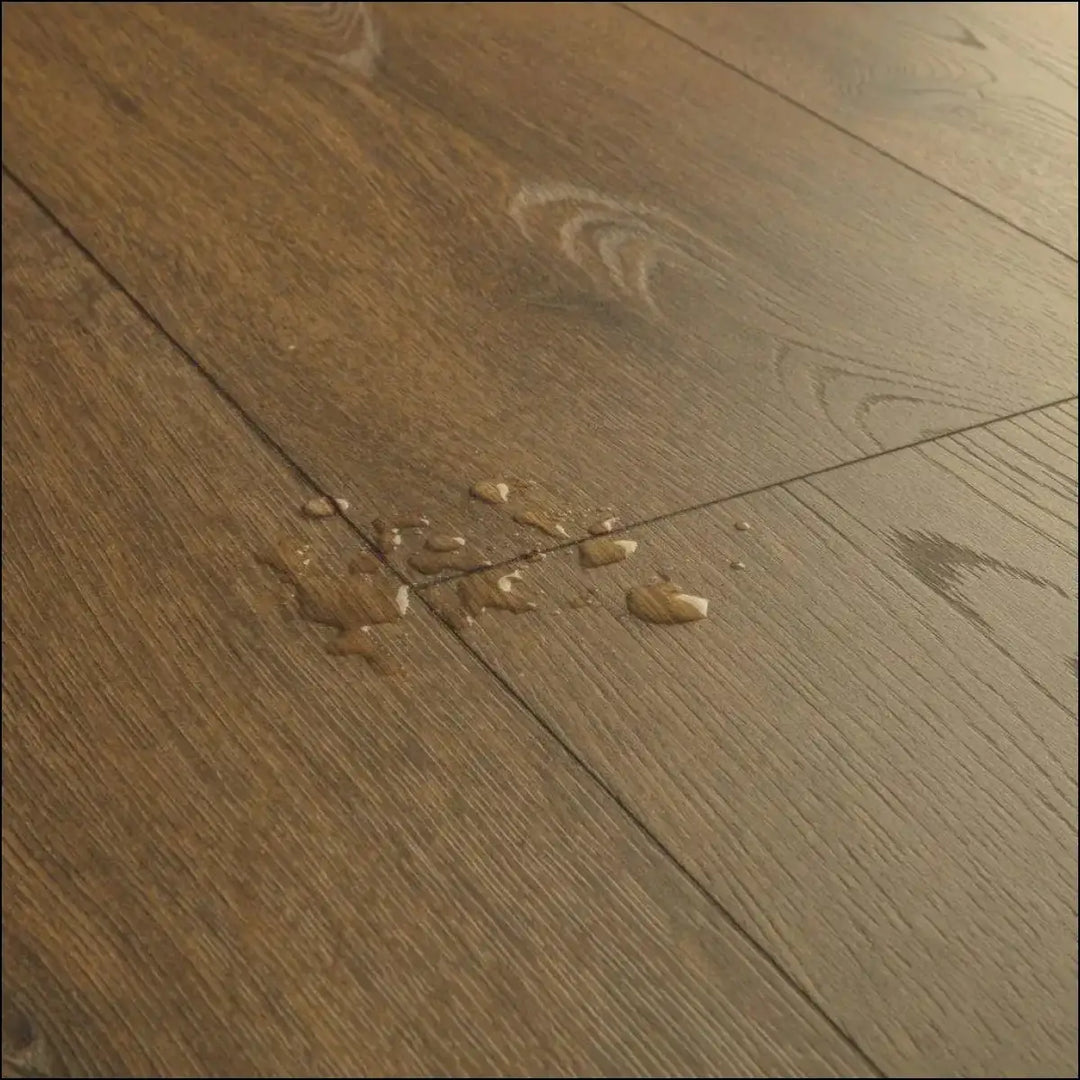 Dark brown hardwood floor with natural wood grain and plank seams in quickstep classic cocoa brown oak laminate clm5793