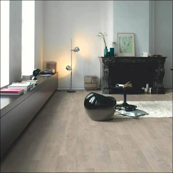 Black glossy egg-shaped chair on quick-step classic laminate flooring old oak light grey with classic laminate flooring