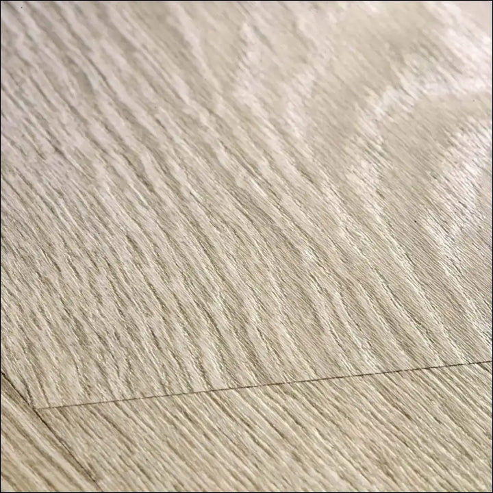 Light beige wood effect quick-step classic laminate flooring with subtle natural grain in old oak light grey finish