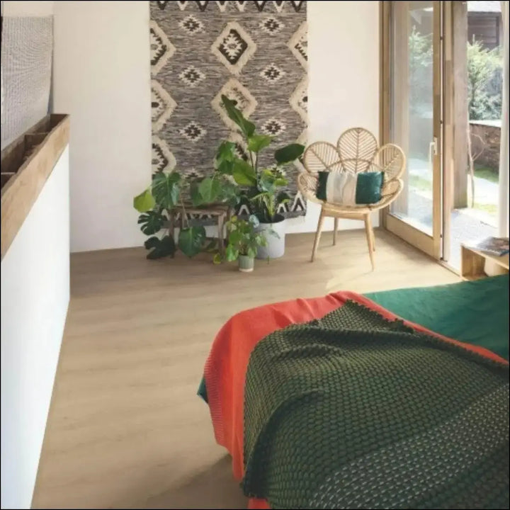 Wicker chair with leaf-patterned back and light natural finish on quickstep classic laminate raw oak flooring