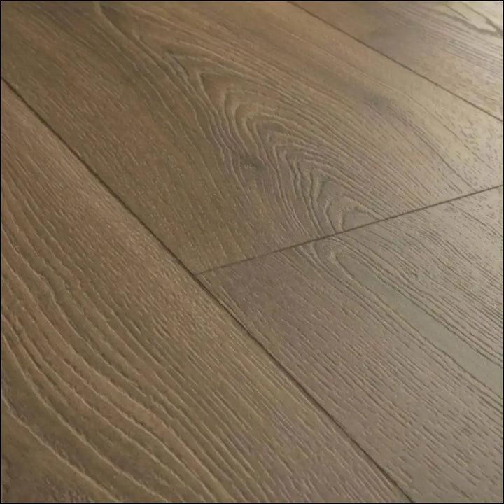Light brown hardwood flooring with natural wood grain in quick-step classic laminate warm brown oak clm5789