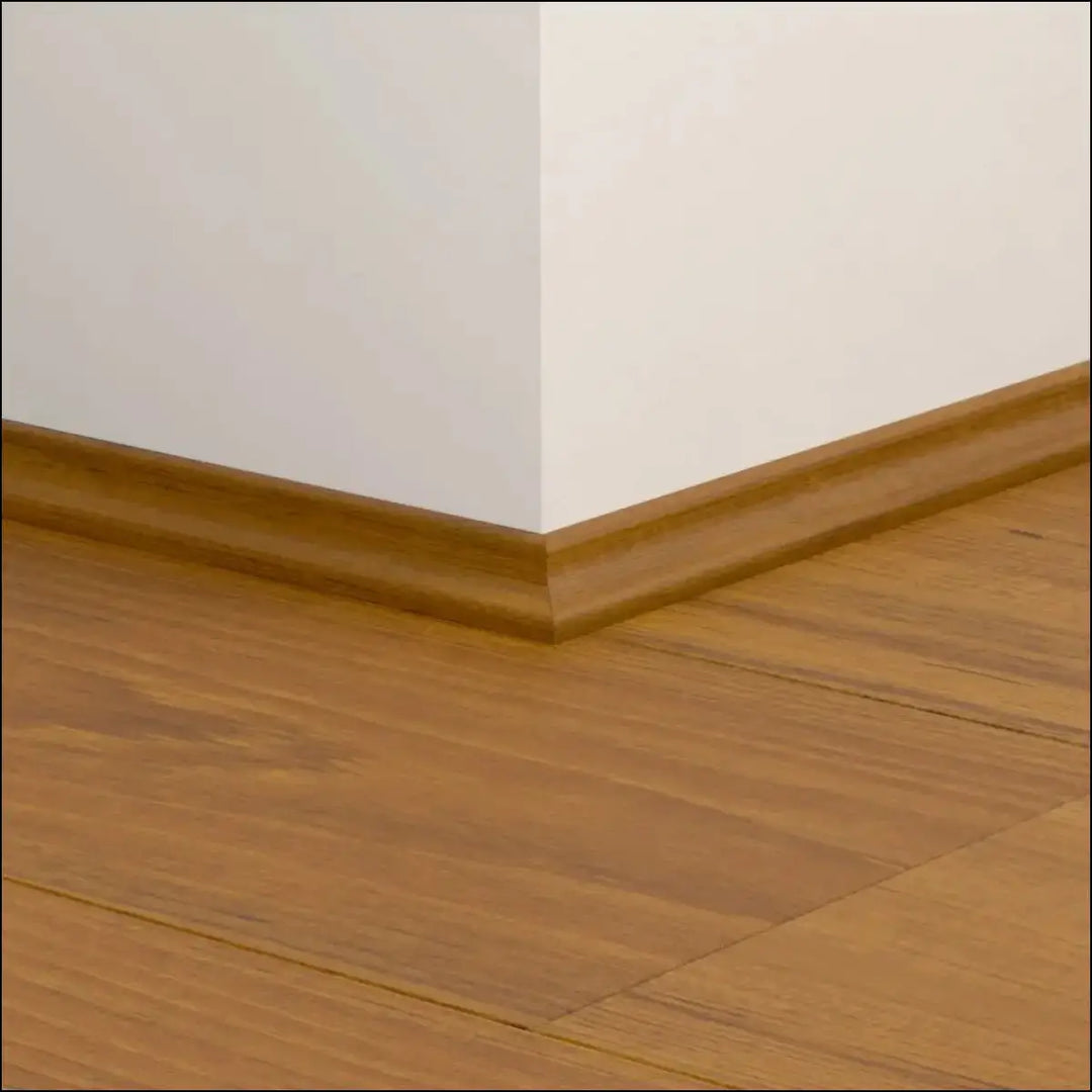 Warm-toned wooden quickstep classic scotia beading with smooth polished finish along floor and wall corner on quick-step flooring