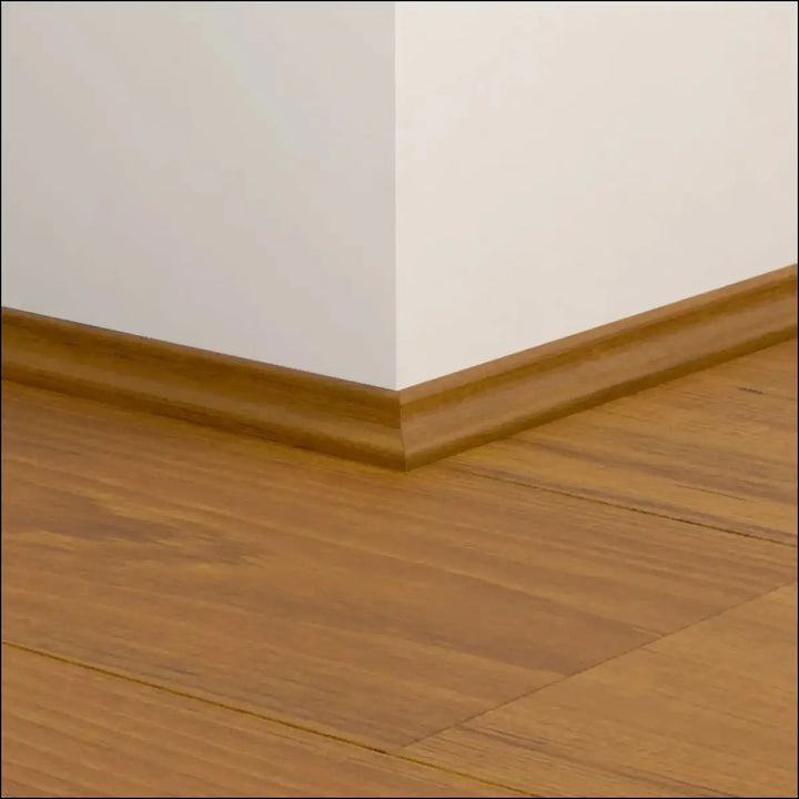 Warm-toned wooden quickstep classic scotia beading with smooth polished finish along floor and wall corner on quick-step flooring