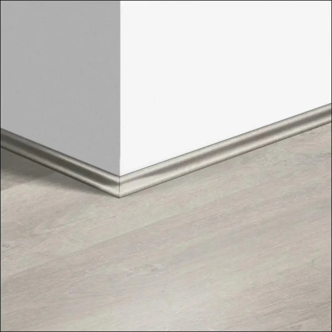 Silver metallic quickstep classic scotia beading with sleek smooth finish along white wall and light gray floor