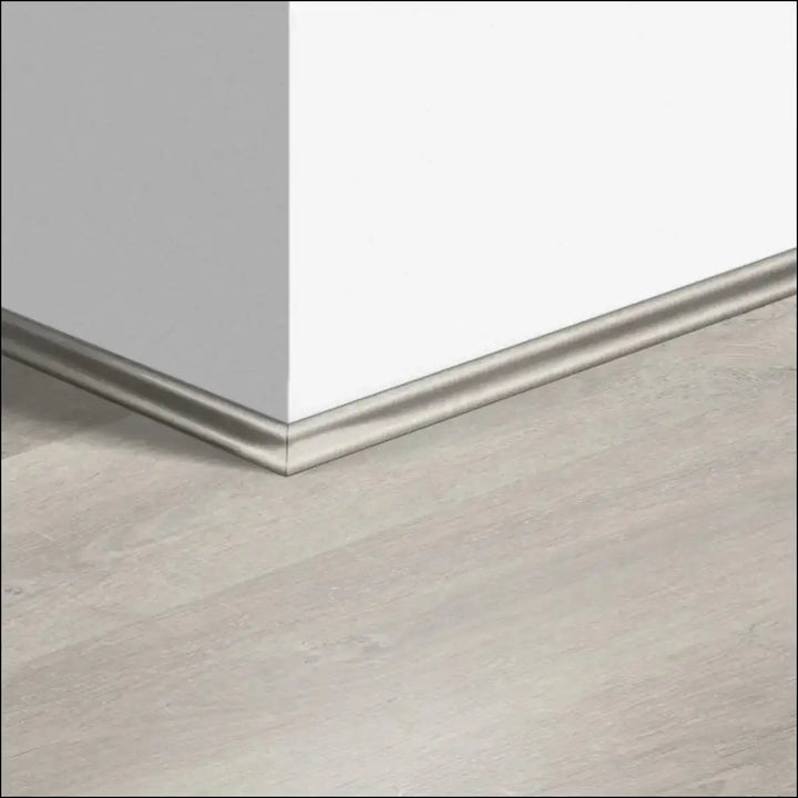 Silver metallic quickstep classic scotia beading with sleek smooth finish along white wall and light gray floor