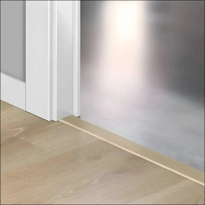 Light beige wooden baseboard trim with quickstep creo incizo profile featuring patented incizo technology along floor wall transition