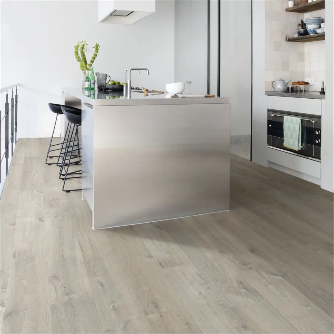 Modern stainless steel kitchen island with integrated sink on quick step impressive soft oak grey laminate flooring