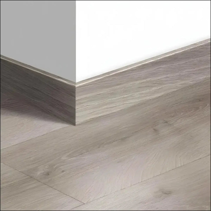 Gray wood-grain laminate quickstep majestic skirting boards 58mm with matte finish matching light gray flooring