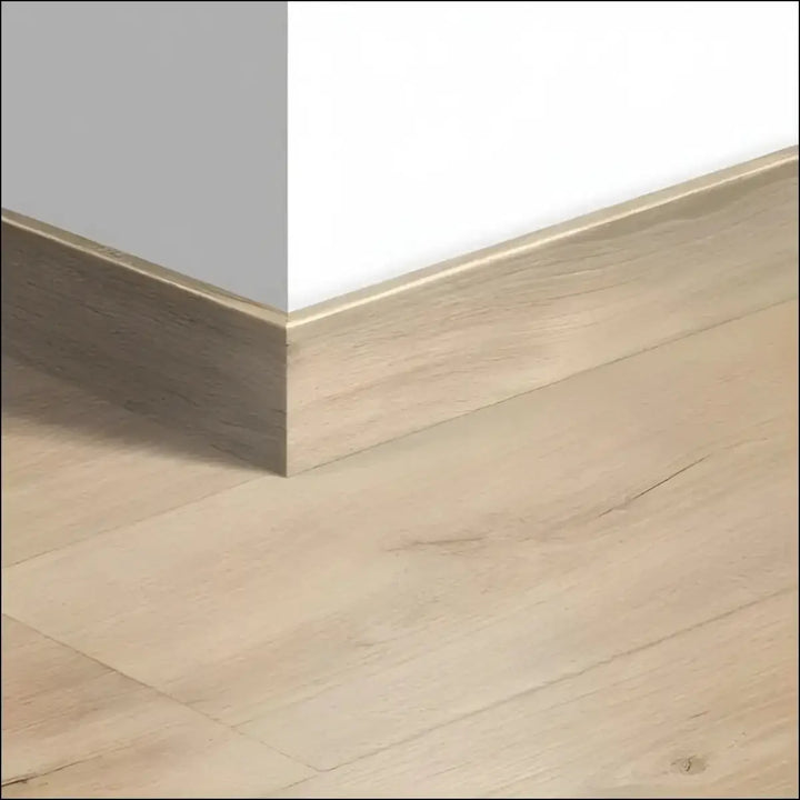 Light oak colored quickstep majestic skirting boards 58mm with wood effect smooth matte finish and subtle grain texture