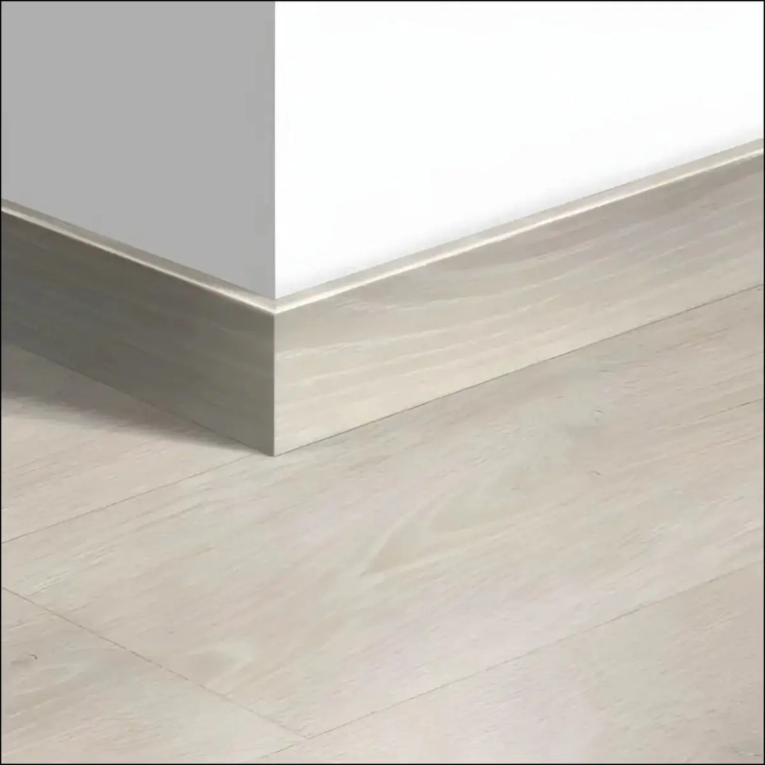 Light gray wood-grain laminate quickstep majestic skirting boards 58mm with a sleek modern profile for baseboards